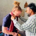 A Finnish guest welcomed with a traditional Nepali scarf